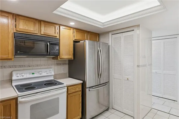 a kitchen with a refrigerator stove and microwave