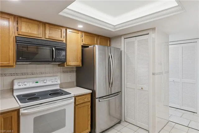 a kitchen with a refrigerator stove and microwave