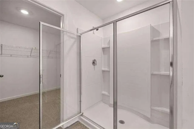 a bathroom with a glass shower door