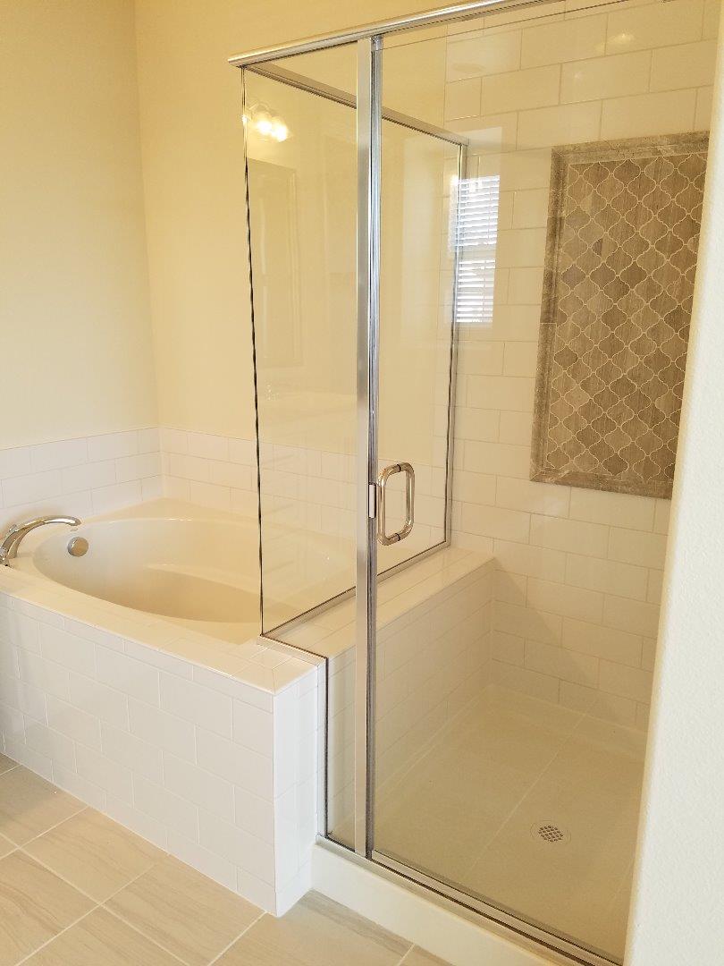 Caspian Way Gilroy, CA 95020 - Photo 8 of 13 a bathroom with a bathtub and shower