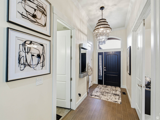 1154 Sunset Dunes Way Draper, UT 84020 - Photo 9 of 50 Entrance foyer featuring hanging lights, dark wood-style flooring, and crown molding
