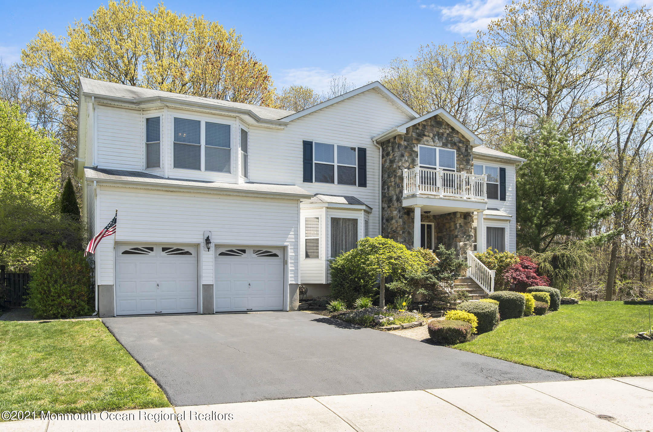 39 Sally Street Howell, NJ 07731 - Photo 3 of 70 a front view of a house with a yard and garage
