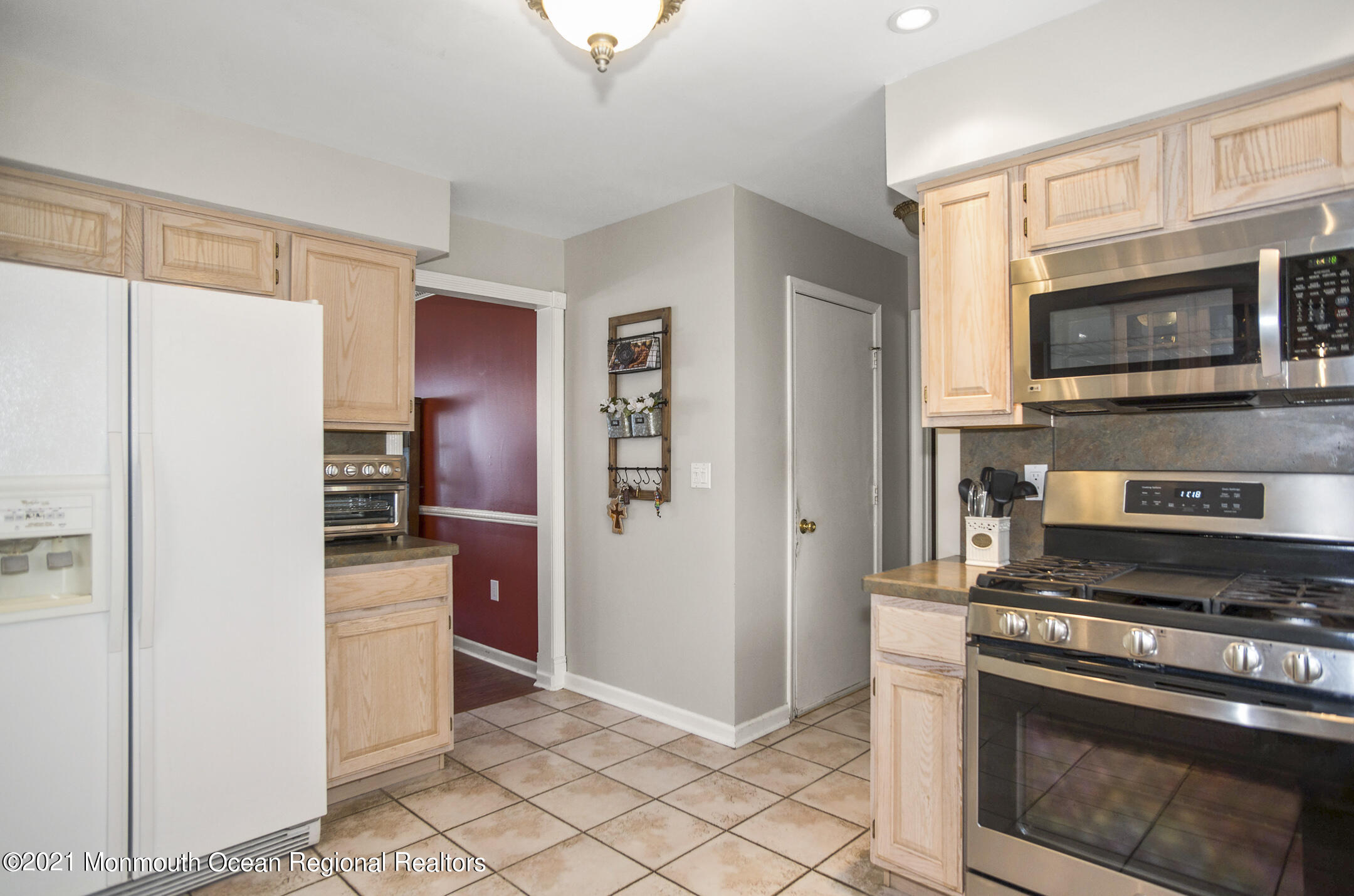 39 Sally Street Howell, NJ 07731 - Photo 26 of 70 a kitchen with stainless steel appliances granite countertop a refrigerator and a stove top oven