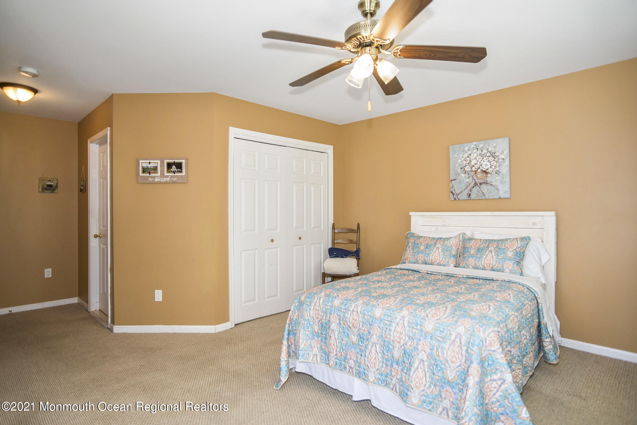 39 Sally Street Howell, NJ 07731 - Photo 33 of 70 a bedroom with a large bed and a chandelier