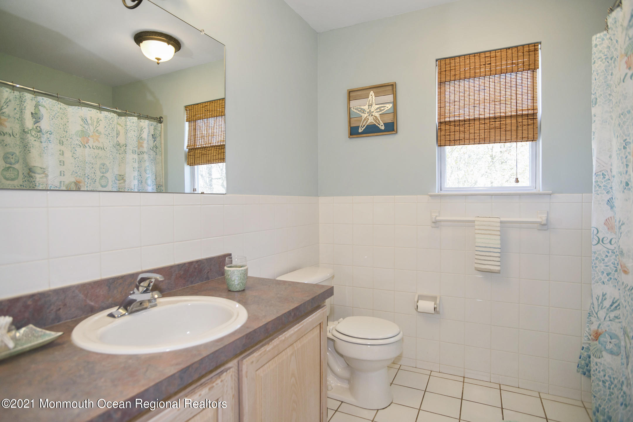 39 Sally Street Howell, NJ 07731 - Photo 43 of 70 a bathroom with a toilet a sink and mirror