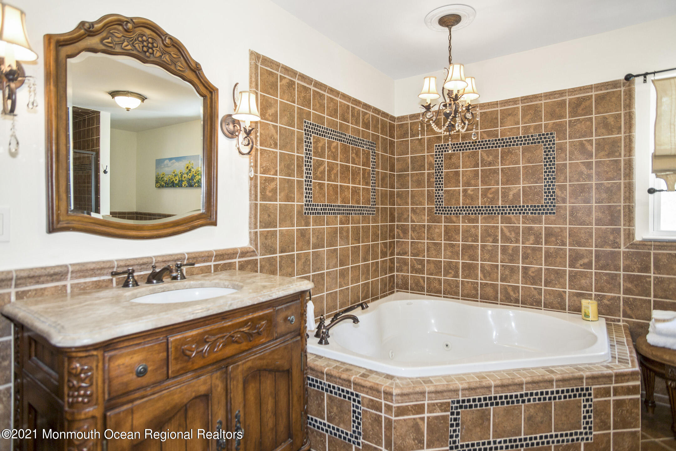39 Sally Street Howell, NJ 07731 - Photo 48 of 70 a bathroom with a tub a sink and a mirror
