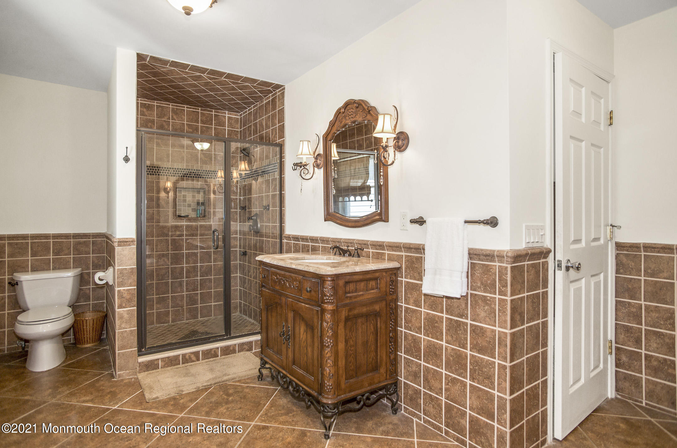 39 Sally Street Howell, NJ 07731 - Photo 50 of 70 a bathroom with a toilet a sink and glass door
