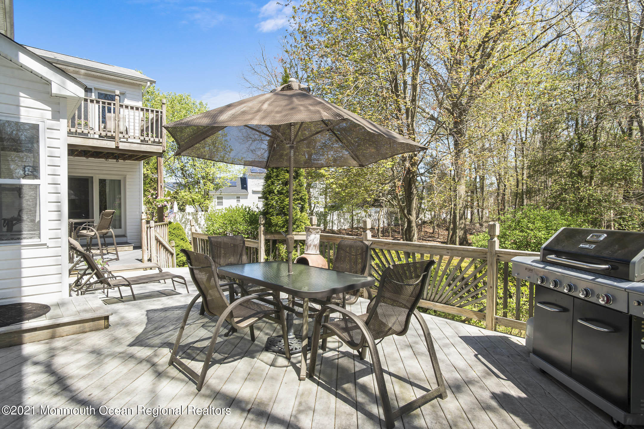 39 Sally Street Howell, NJ 07731 - Photo 57 of 70 a view of a patio with a table chairs and a barbeque
