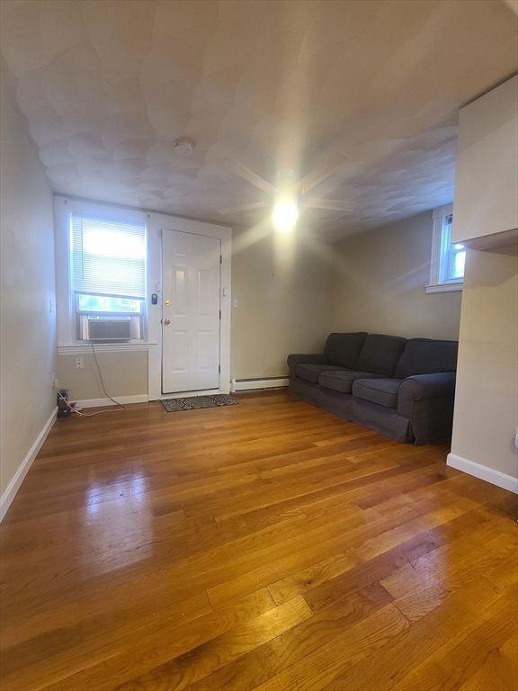 a view of empty room with wooden floor