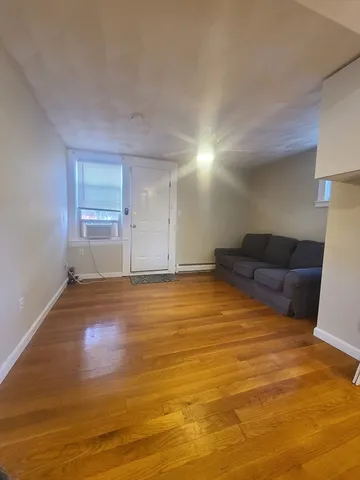 a big room with wooden floor and furniture