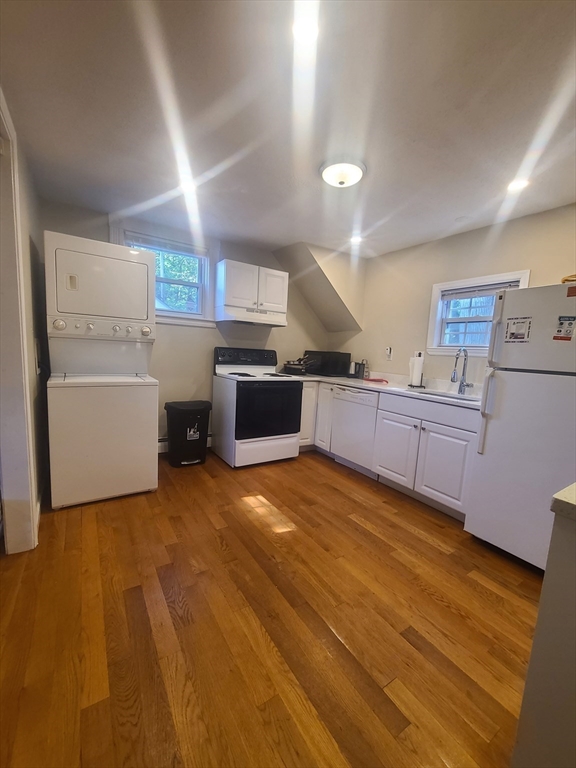 39 Florence Street, Unit 2 Worcester, MA 01610 - Photo 3 of 10 a large kitchen with a lot of cabinets and wooden floor