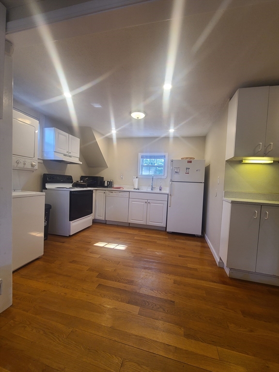 39 Florence Street, Unit 2 Worcester, MA 01610 - Photo 5 of 10 a view of a kitchen with a sink stove cabinets and empty room