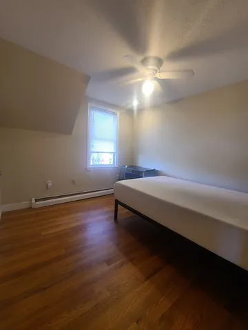 a spacious bedroom with a bed and a chandelier