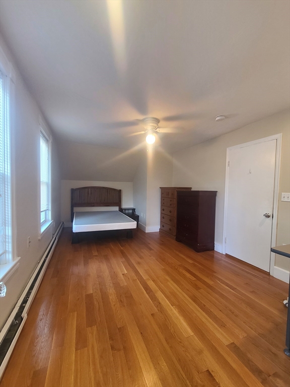 39 Florence Street, Unit 2 Worcester, MA 01610 - Photo 9 of 10 a view of an empty room with wooden floor and a window
