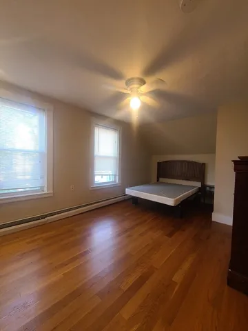 an empty room with window and wooden floor