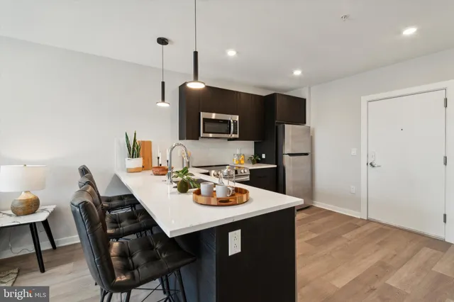a open kitchen with a dining table and chairs