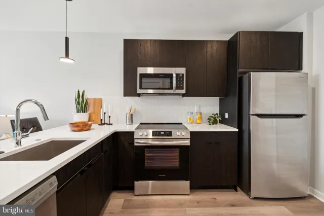 a kitchen with a refrigerator and a sink