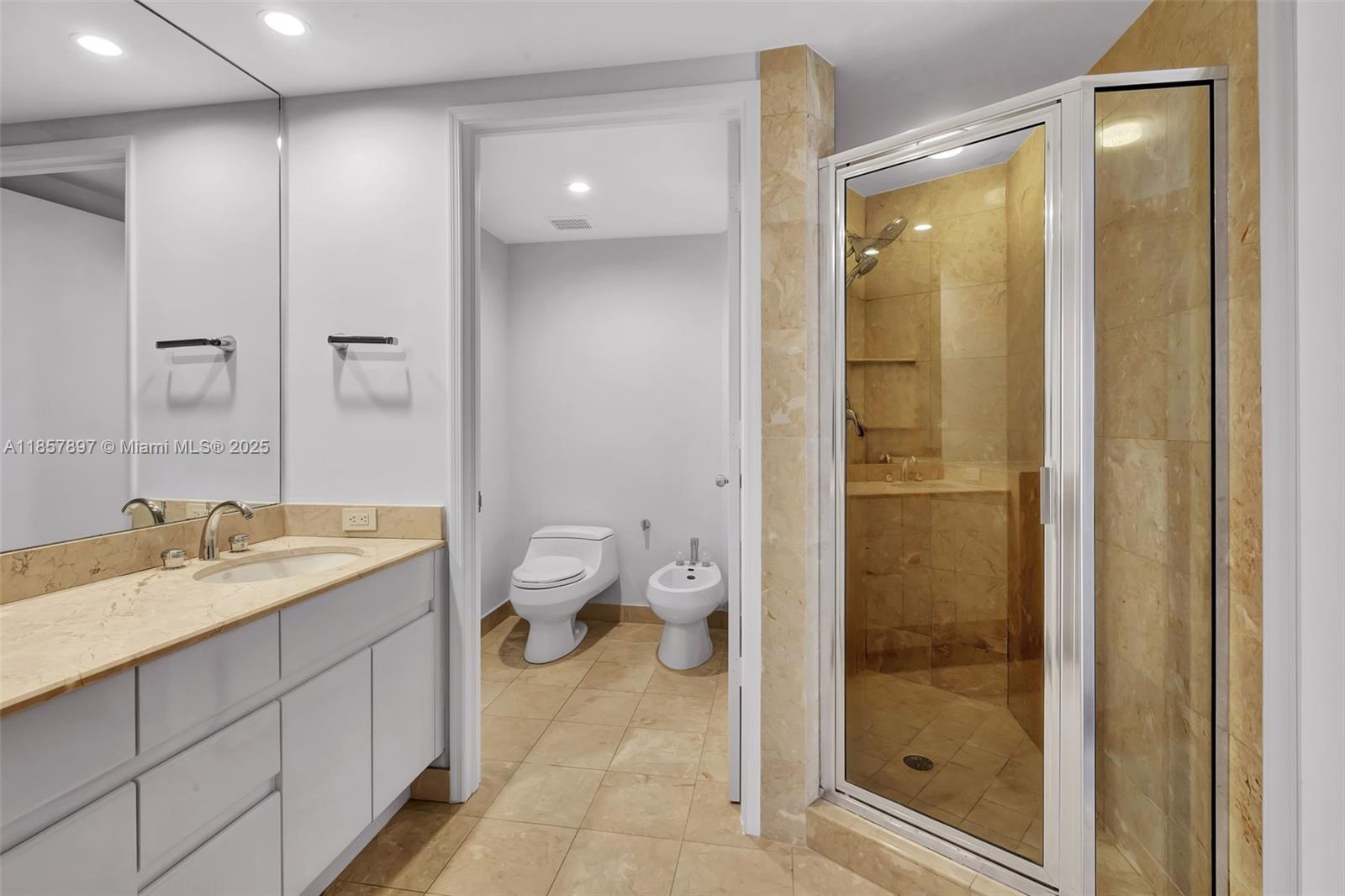 848 Brickell Key Drive, Unit 2602 Miami, FL 33131 - Photo 26 of 40 a spacious bathroom with a granite countertop sink toilet and shower