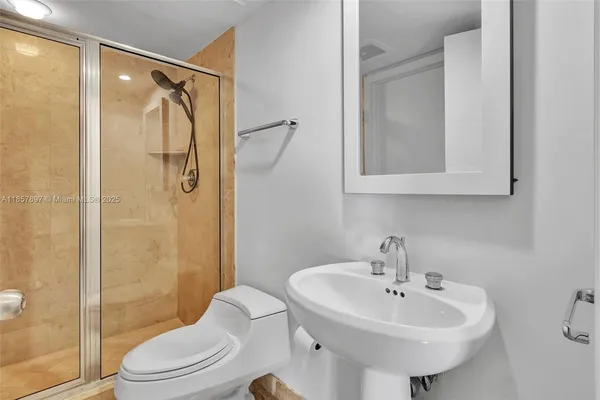 a bathroom with a sink toilet and shower