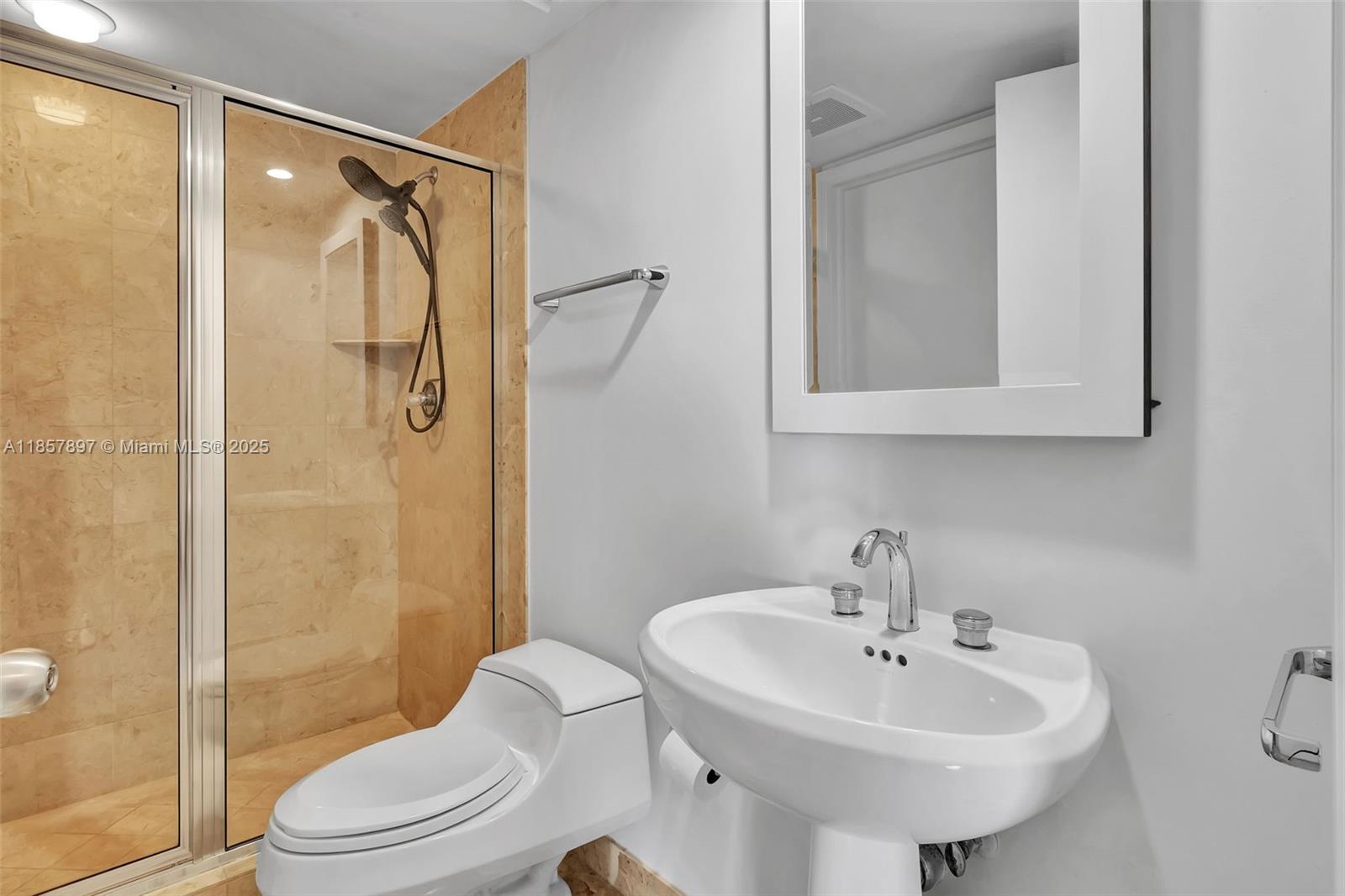 848 Brickell Key Drive, Unit 2602 Miami, FL 33131 - Photo 28 of 40 a bathroom with a sink toilet and shower