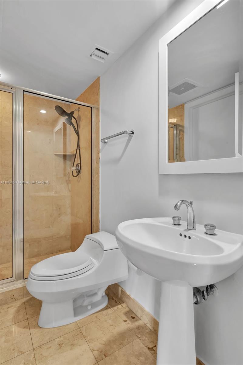848 Brickell Key Drive, Unit 2602 Miami, FL 33131 - Photo 29 of 40 a bathroom with a sink toilet and shower