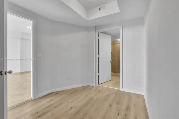 an empty room with wooden floor