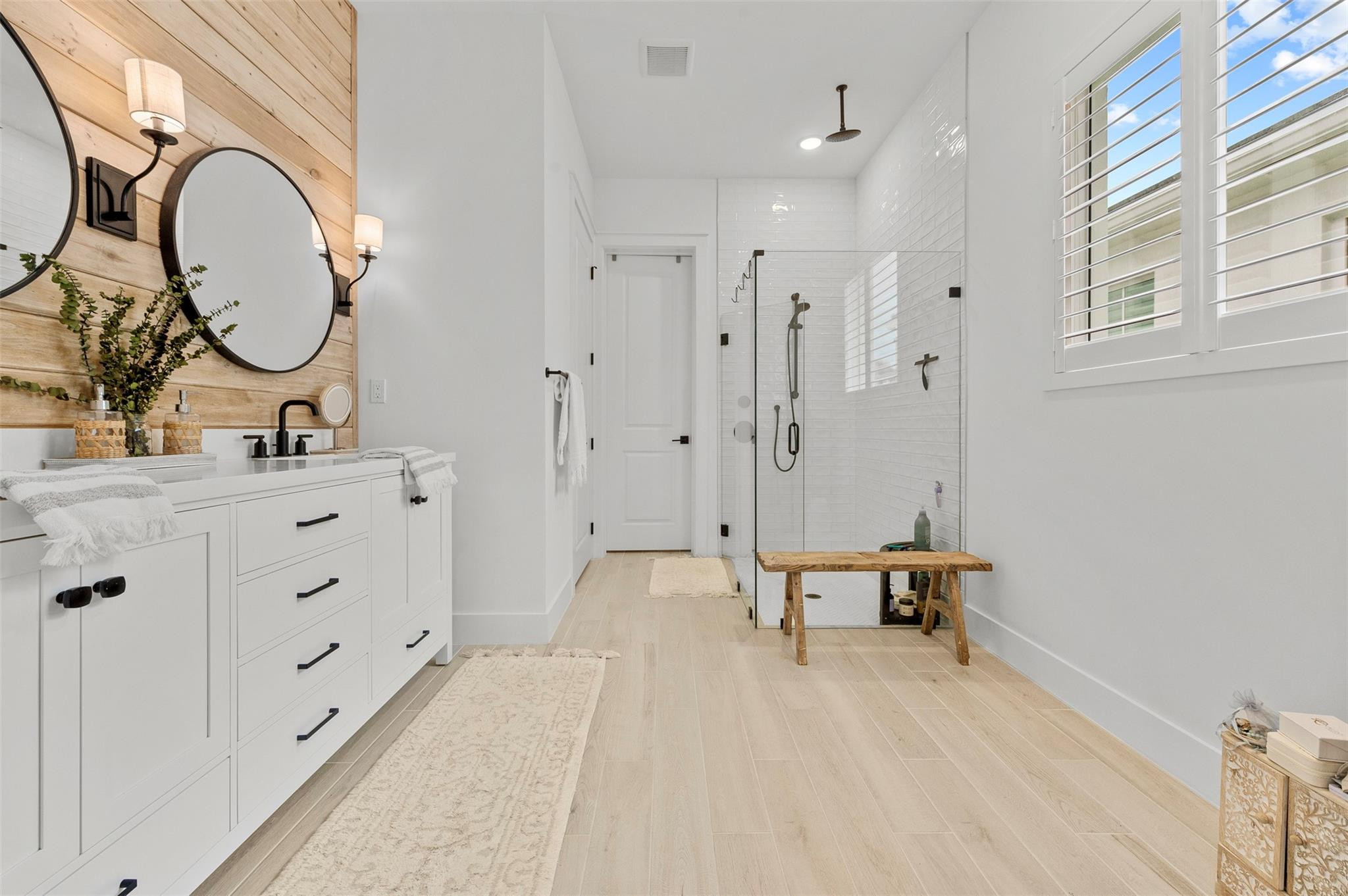 121 Southeast Rocky Terrace Stuart, FL 34997 - Photo 15 of 45 a spacious bathroom with a double vanity sink a mirror and a shower