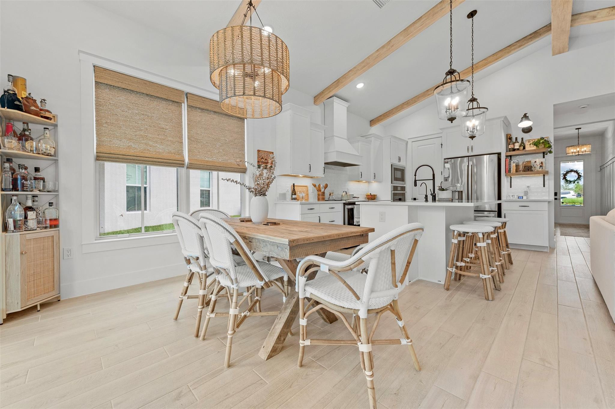 121 Southeast Rocky Terrace Stuart, FL 34997 - Photo 16 of 45 a dining room with stainless steel appliances kitchen island granite countertop a table chairs and a chandelier