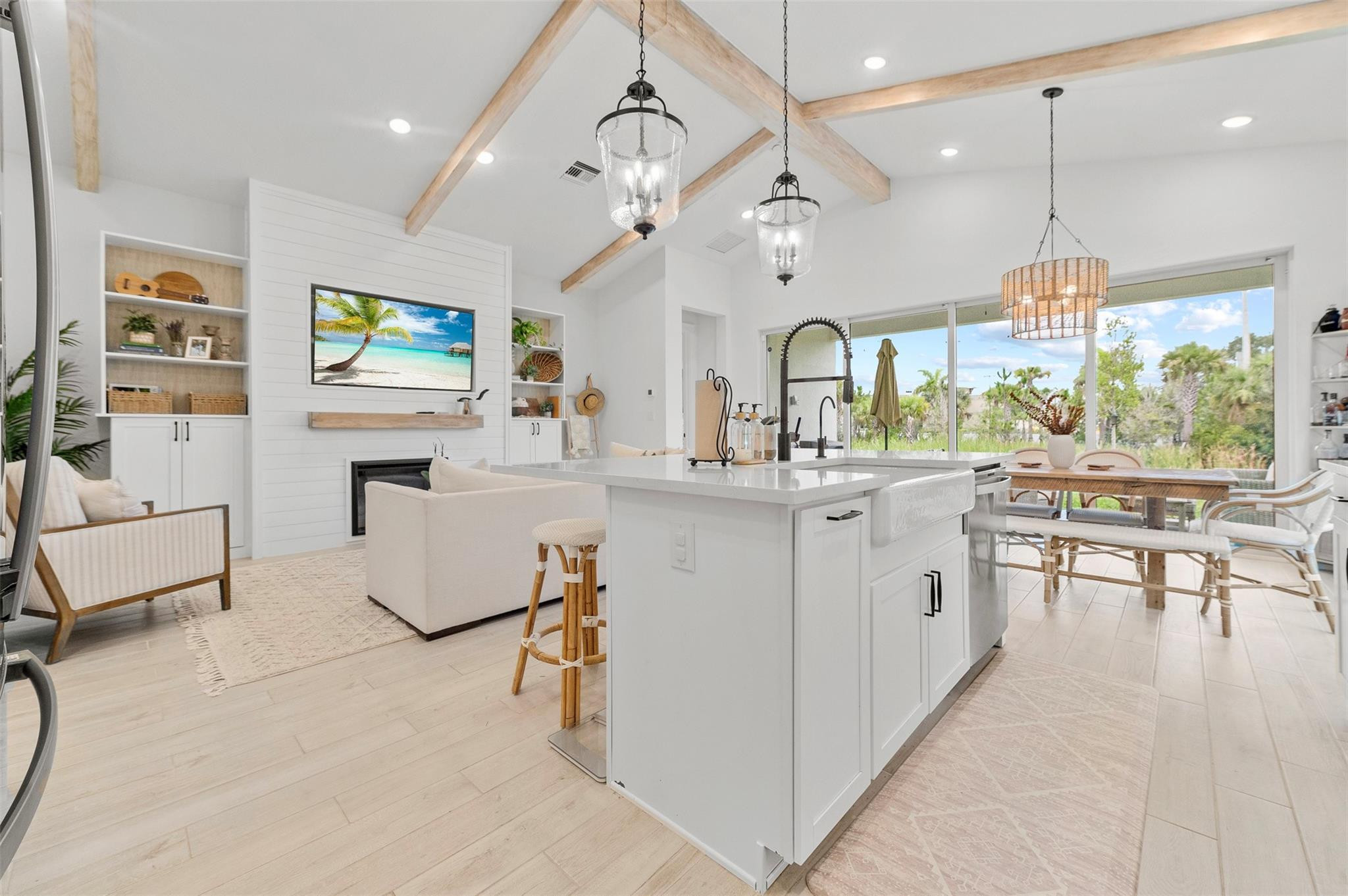 121 Southeast Rocky Terrace Stuart, FL 34997 - Photo 19 of 45 a kitchen with kitchen island granite countertop a stove a sink a dining table and chairs with wooden floor