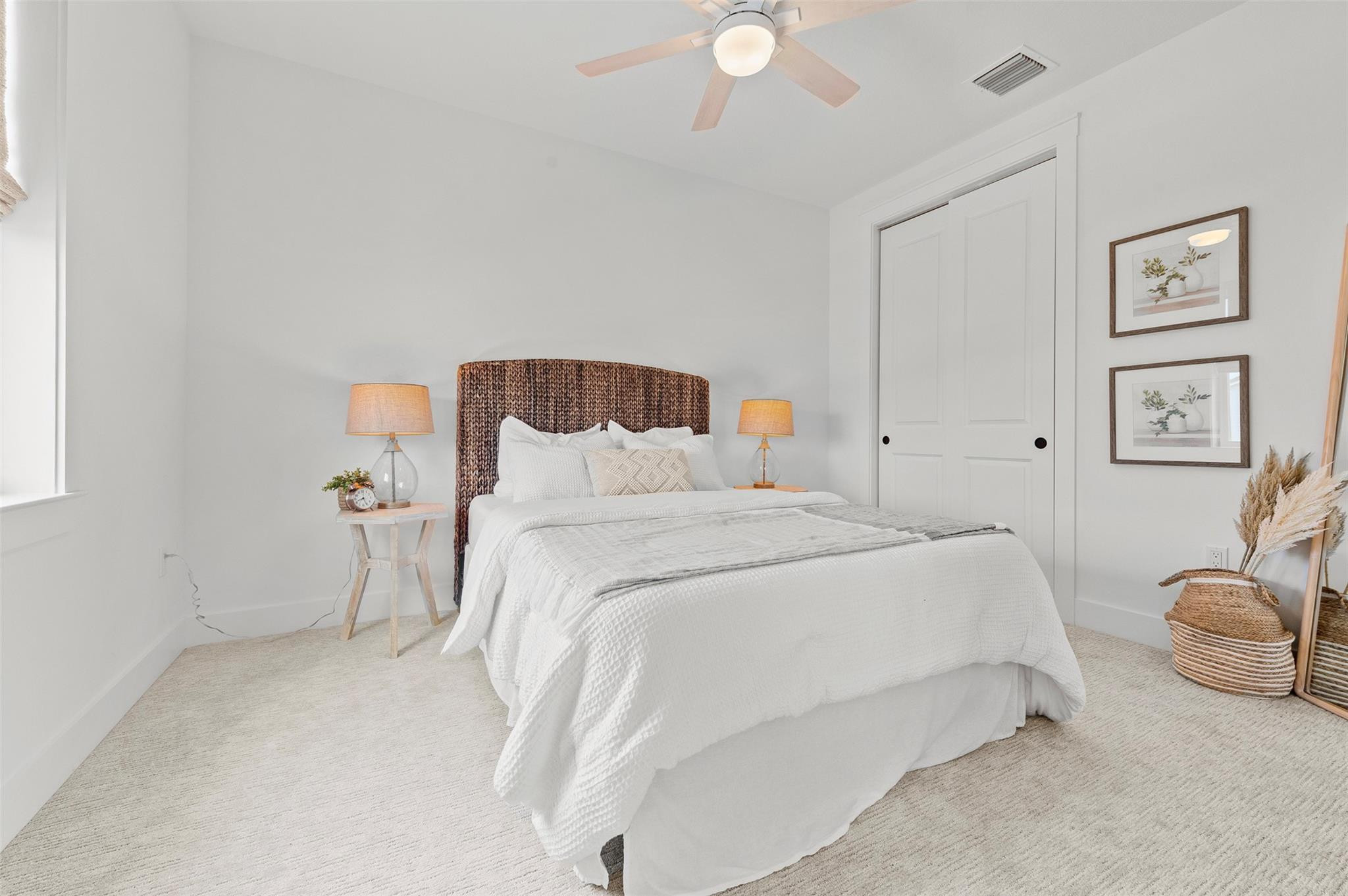 121 Southeast Rocky Terrace Stuart, FL 34997 - Photo 28 of 45 a bedroom with a bed and lamp