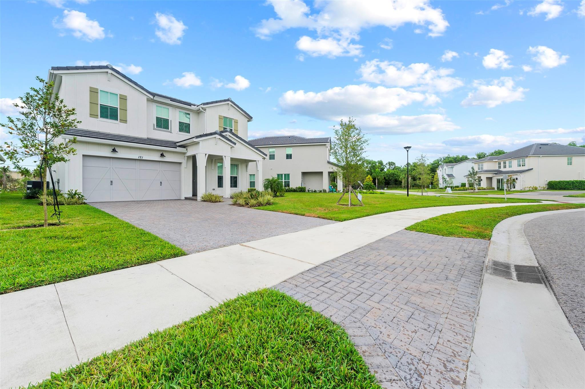 121 Southeast Rocky Terrace Stuart, FL 34997 - Photo 4 of 45 a view of a big house with a big yard and large trees