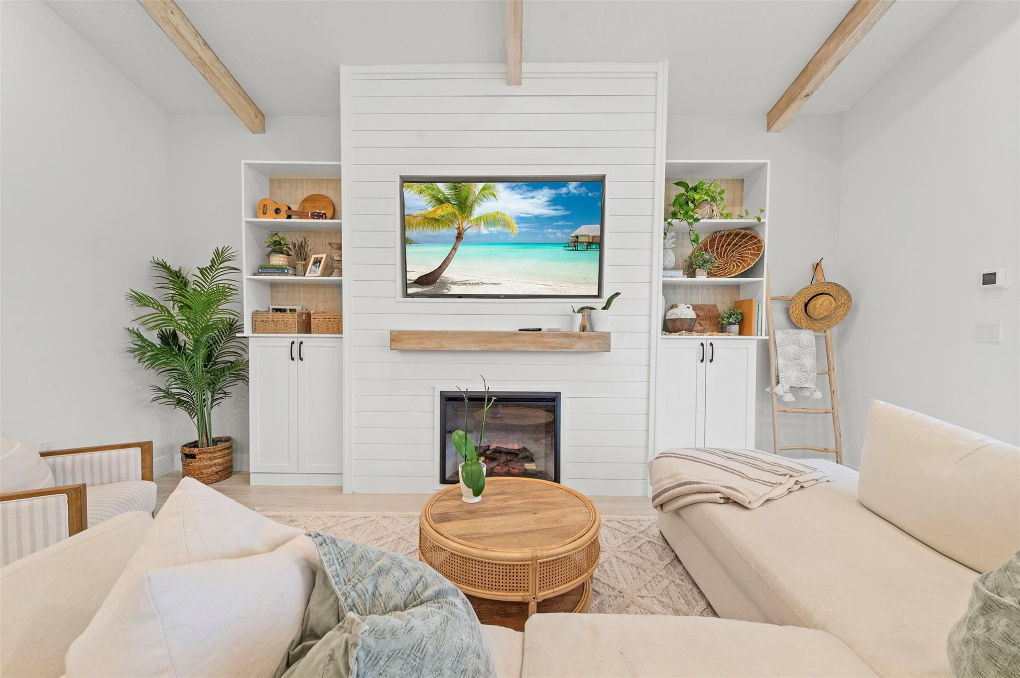 121 Southeast Rocky Terrace Stuart, FL 34997 - Photo 7 of 45 a living room with furniture a fireplace and potted plants
