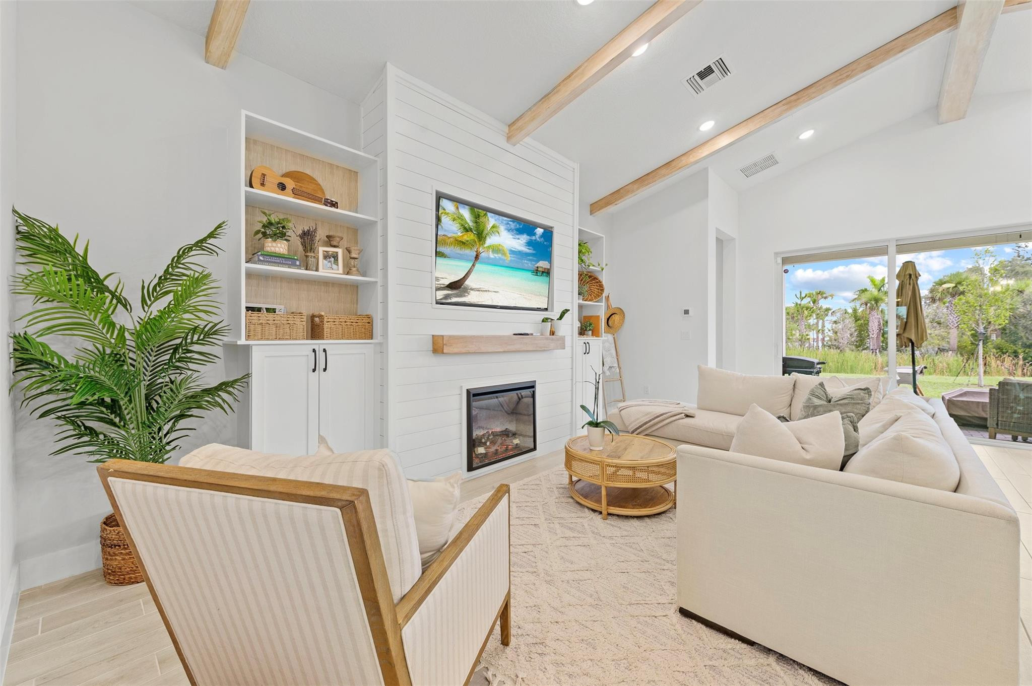 121 Southeast Rocky Terrace Stuart, FL 34997 - Photo 9 of 45 a living room with furniture a fireplace and a flat screen tv