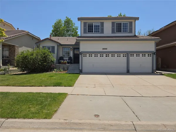 a front view of a house with yard