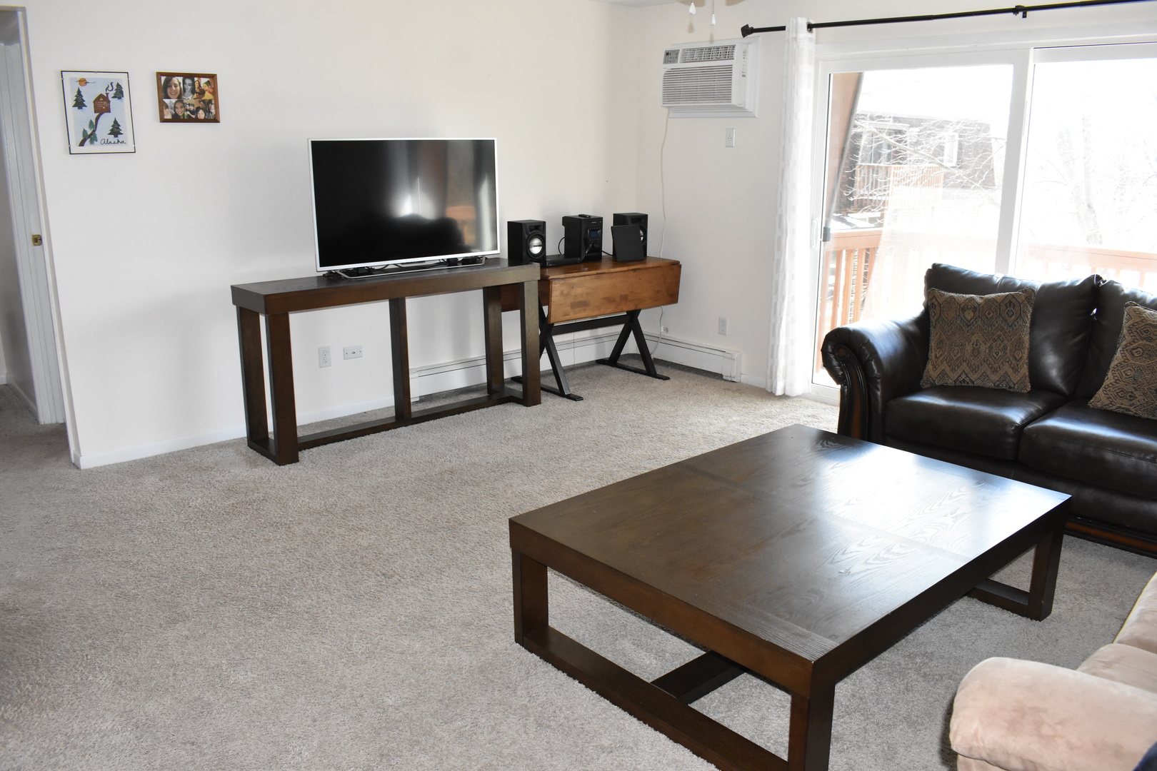 19380 Wolf Road, Unit 9 Mokena, IL 60448 - Photo 4 of 13 a living room with furniture and a flat screen tv