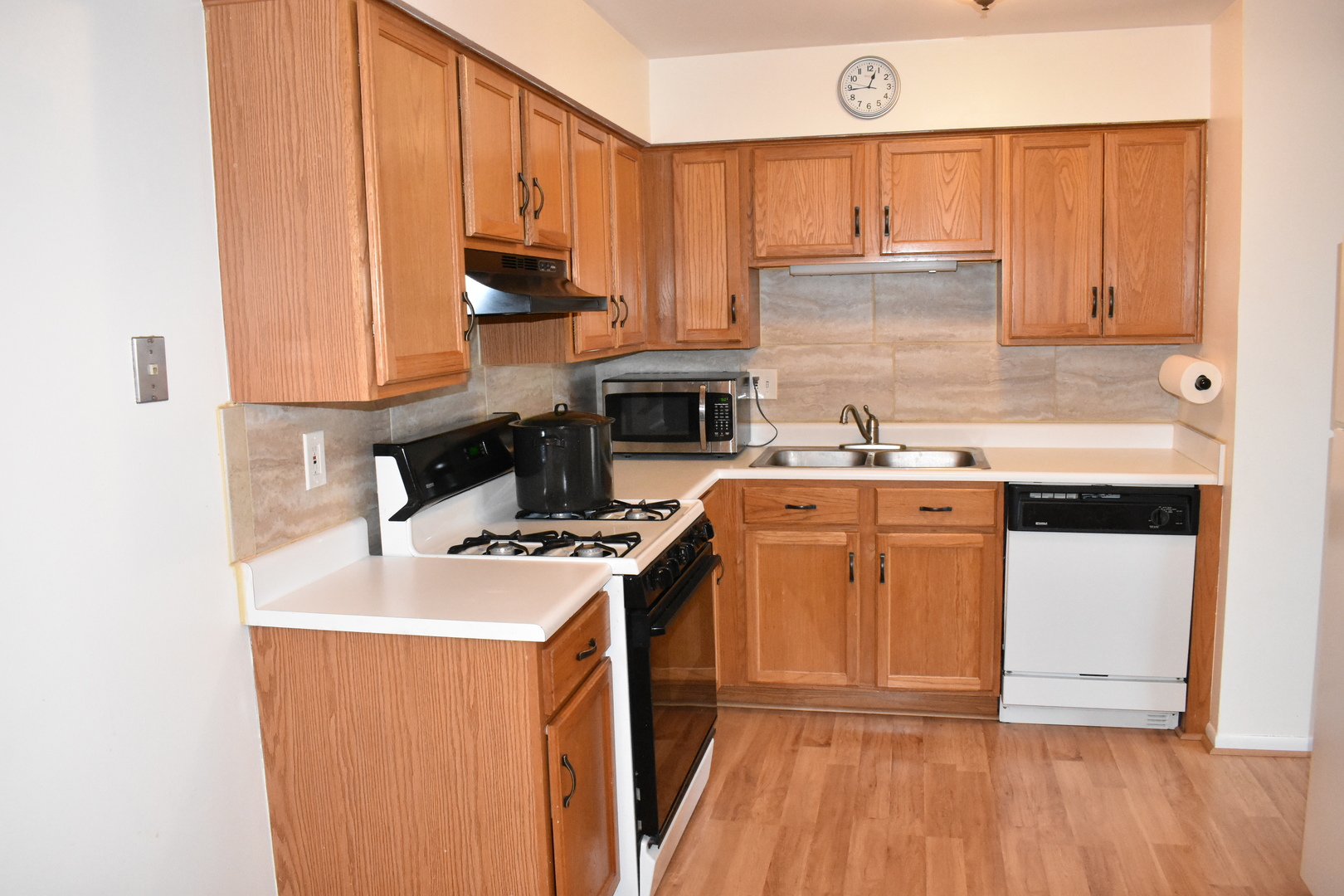 19380 Wolf Road, Unit 9 Mokena, IL 60448 - Photo 7 of 13 a kitchen with a sink a stove and cabinets