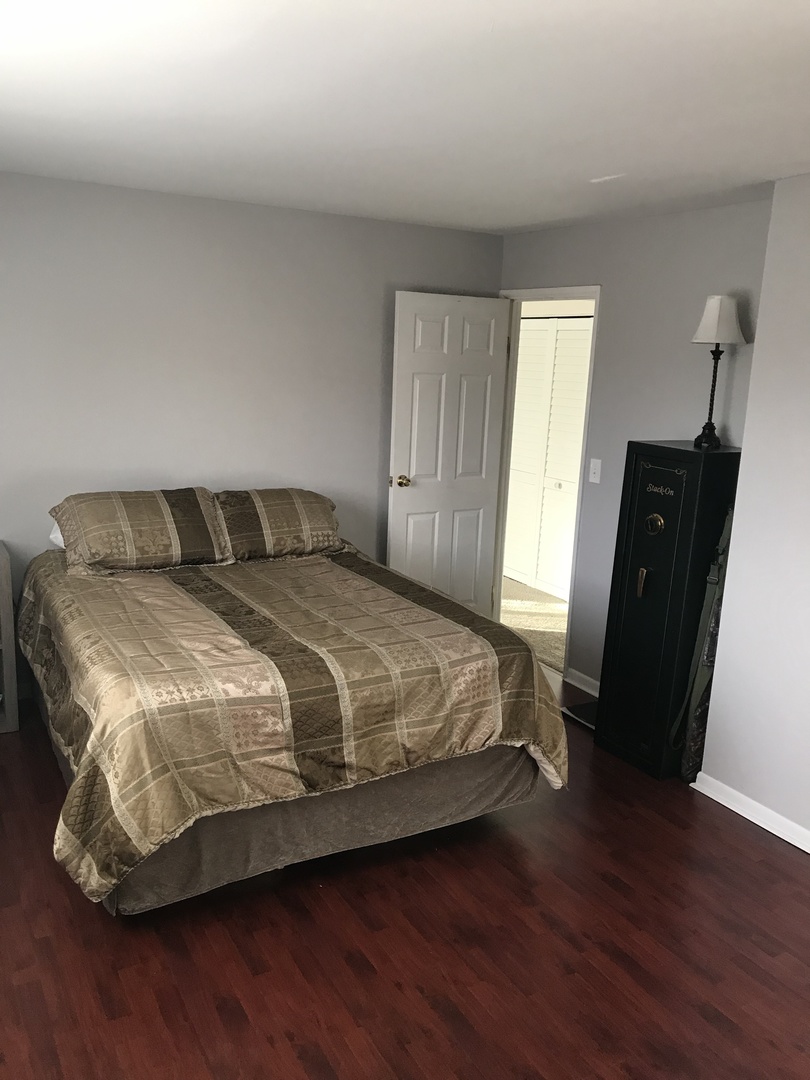 19380 Wolf Road, Unit 9 Mokena, IL 60448 - Photo 9 of 13 a bedroom with a bed and wooden floor