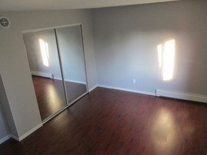 19380 Wolf Road, Unit 9 Mokena, IL 60448 - Photo 10 of 13 an empty room with wooden floor and windows