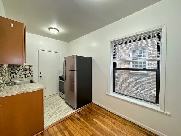 a view of kitchen with utility cabinet and a window