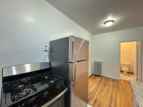 a kitchen with a stove and a refrigerator
