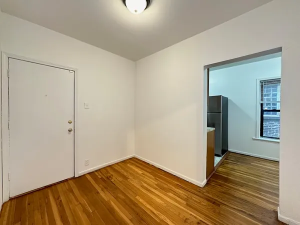 a view of a room with wooden floor