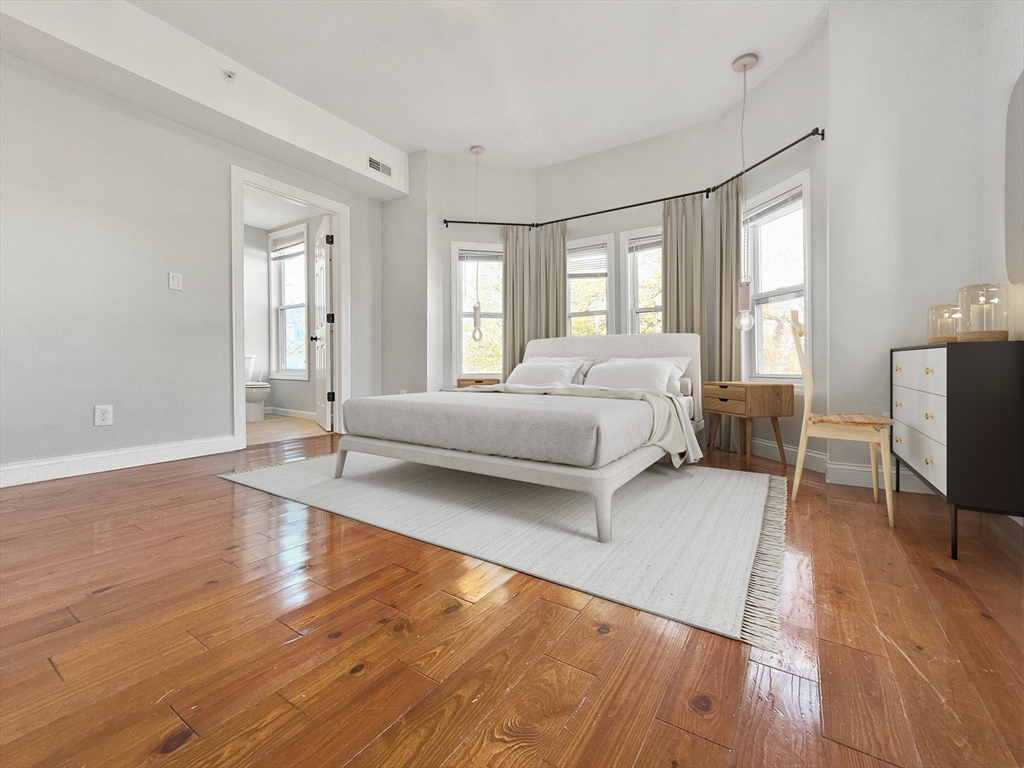 26 Arcadia Street, Unit 2L Boston, MA 02122 - Photo 1 of 9 a spacious bedroom with a bed window and a flat tv screen