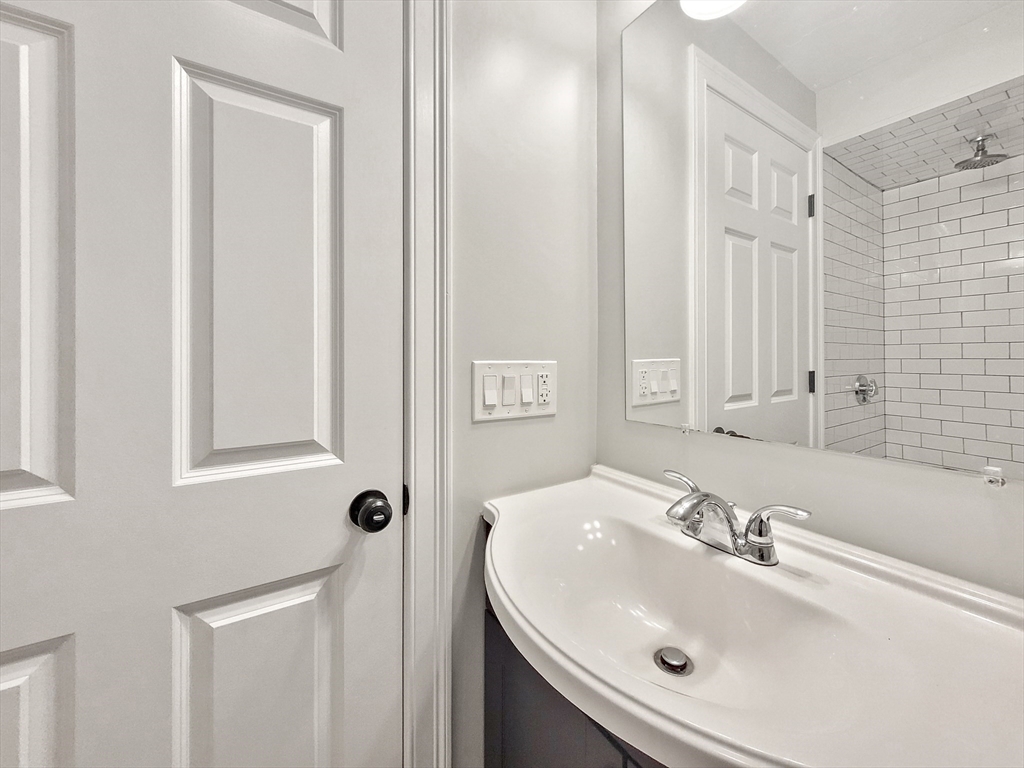 26 Arcadia Street, Unit 2L Boston, MA 02122 - Photo 8 of 9 a bathroom with a sink and a mirror