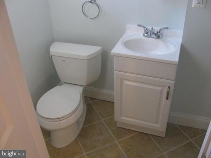 1629 Northgate Road Baltimore, MD 21218 - Photo 14 of 29 a white toilet sitting next to a bathroom sink