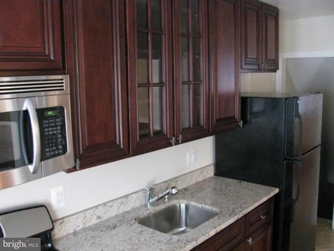 1629 Northgate Road Baltimore, MD 21218 - Photo 5 of 29 a kitchen with a sink refrigerator and cabinets