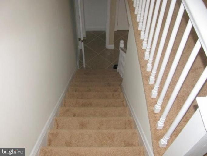1629 Northgate Road Baltimore, MD 21218 - Photo 8 of 29 a view of staircase with white walls and window