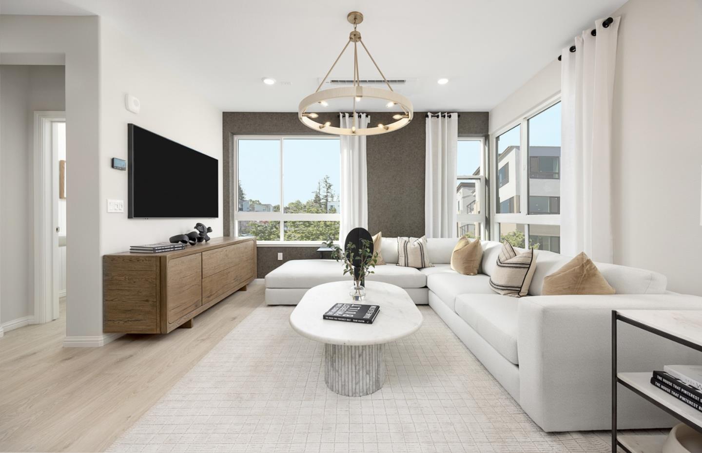 1145 Milan Terrace, Unit 9 Sunnyvale, CA 94089 - Photo 8 of 20 a living room with furniture a chandelier and a flat screen tv