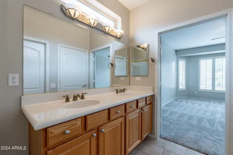 a bathroom with a sink double vanity and a mirror