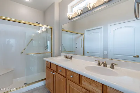 a bathroom with a sink double vanity and a mirror