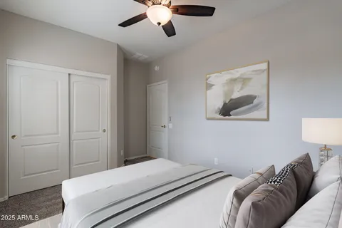 a bedroom with a bed and a painting on the wall